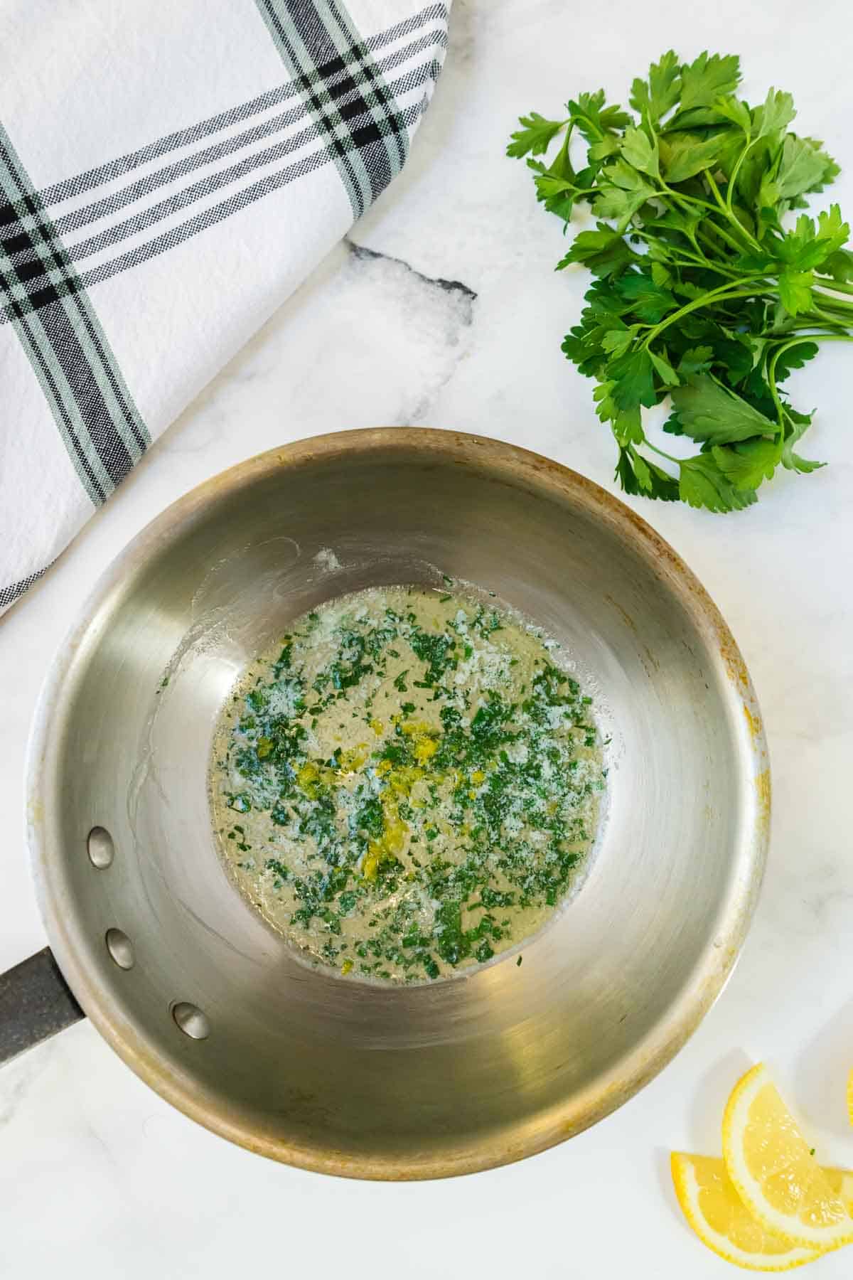 A pan with the herb butter sauce.
