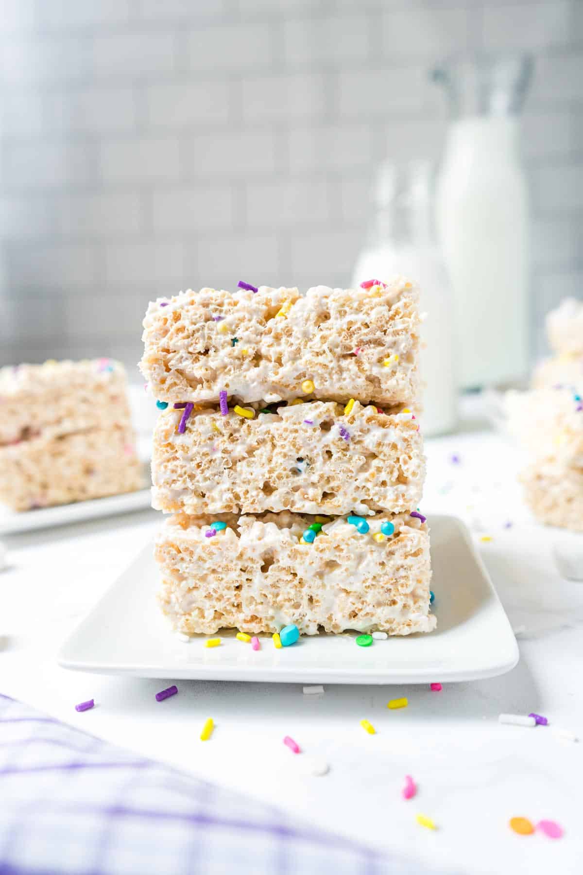 A stack of three squares of rice krispie treat made with marshmallow fluff.