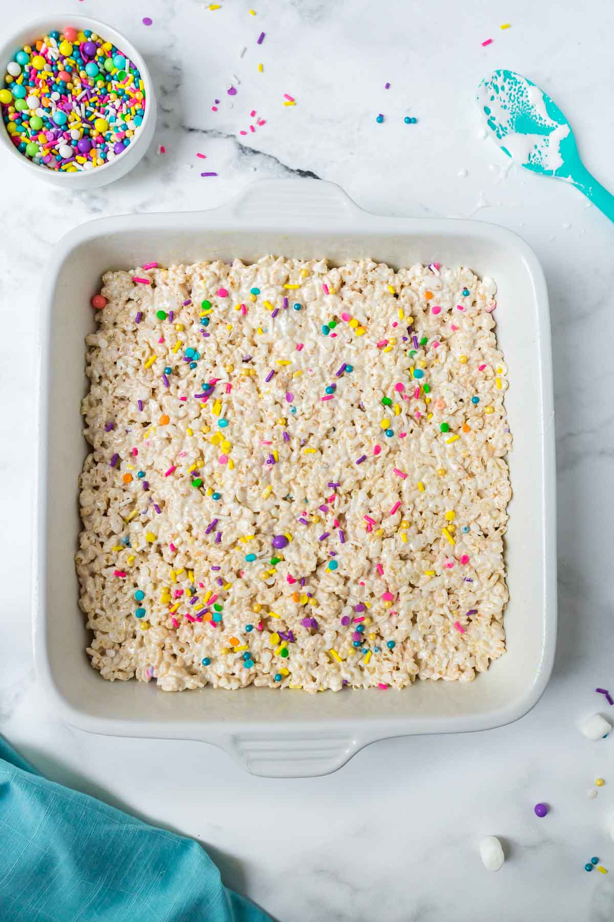 A complete pan of rice krispie treats with sprinkles on top.