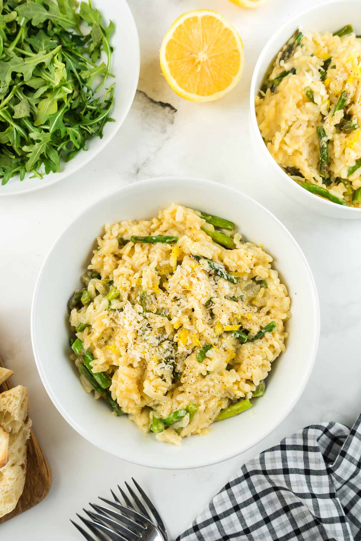 A bowl of Instant Pot Risotto with Asparagus with a green arugula salad on the side.