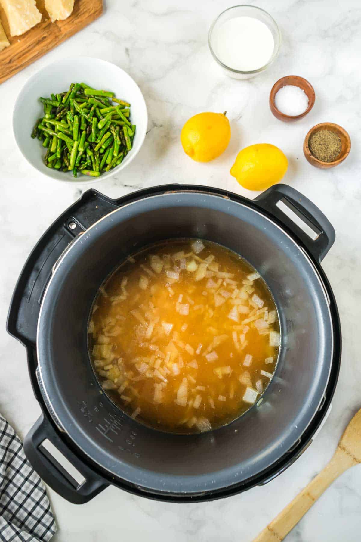 Chicken stock being added to the instant pot risotto.