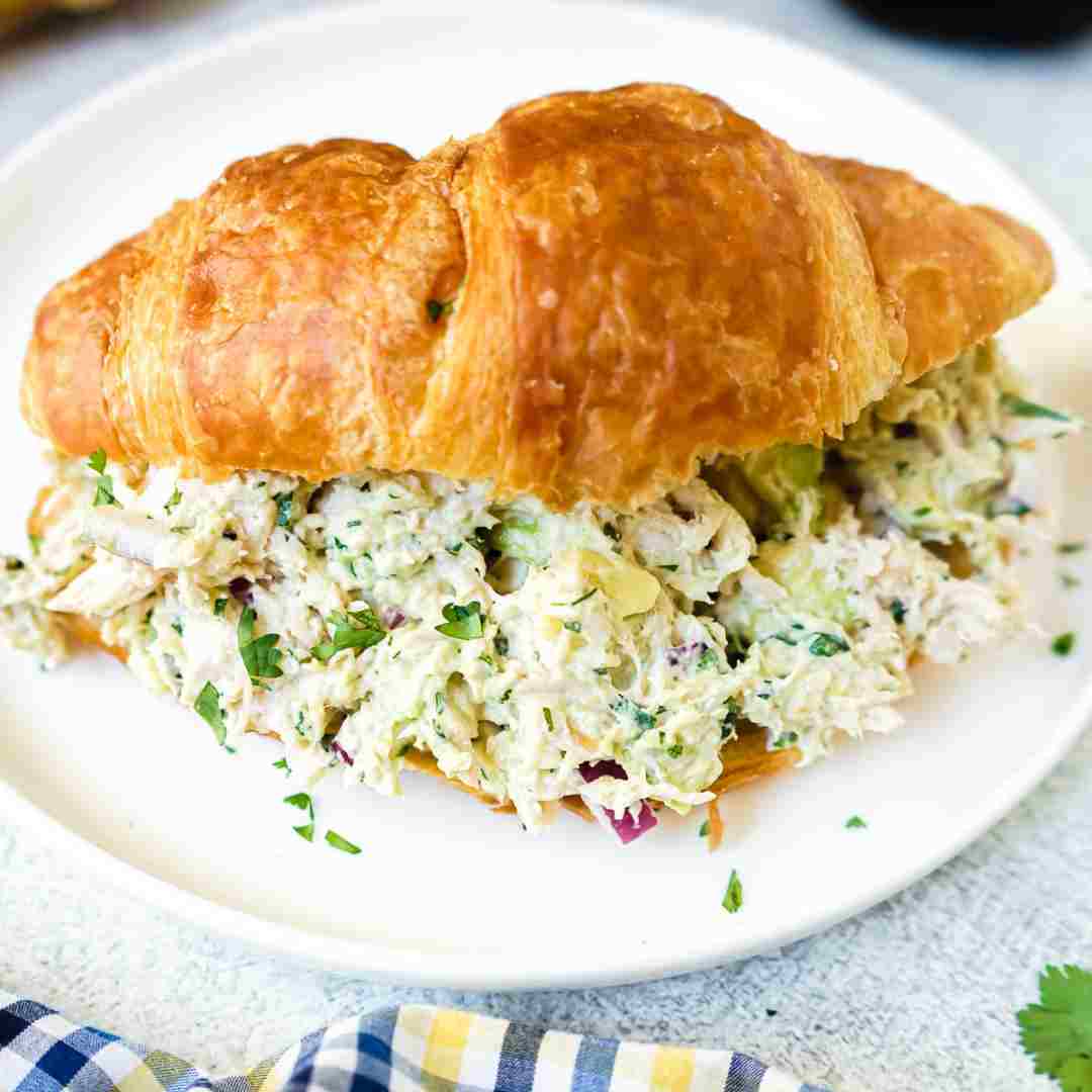 Featured image for californai chicken salad with avacado on a crossiant.