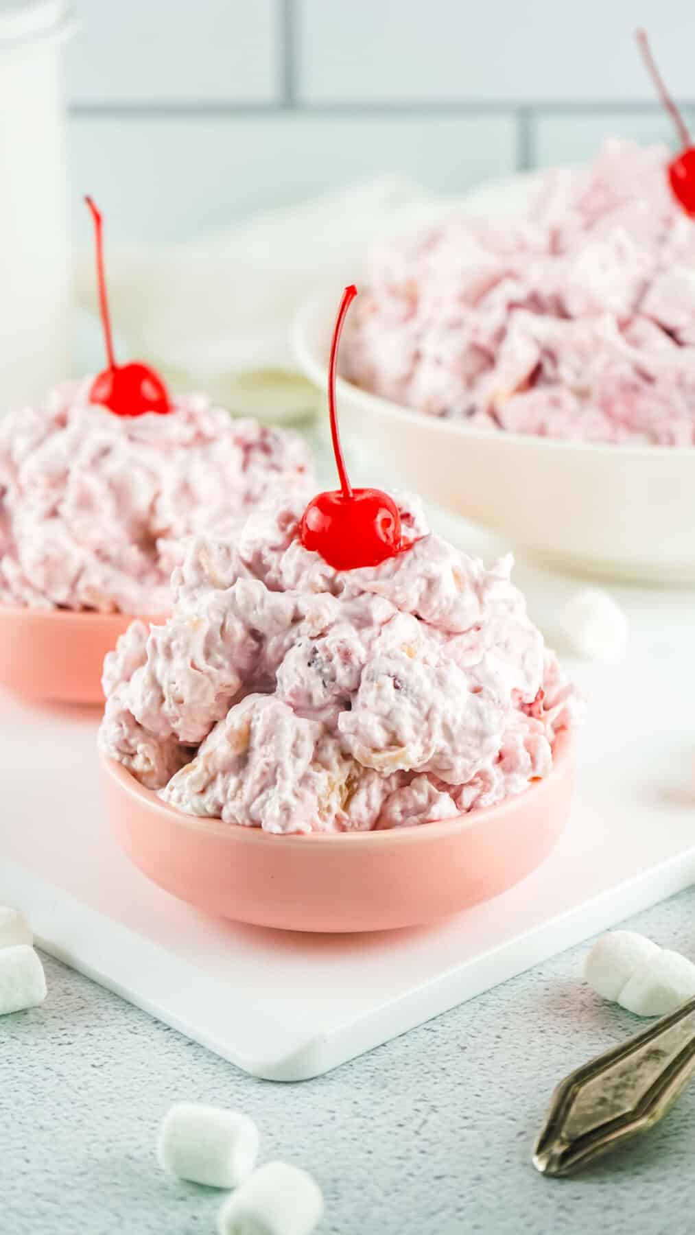 Cherry fluff salad in a small pink bowl.