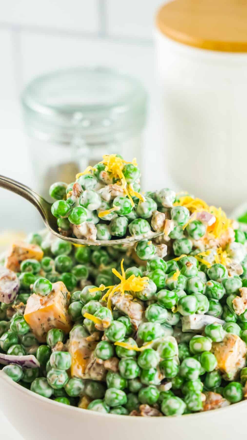 Close up of pea salad on a spoon.