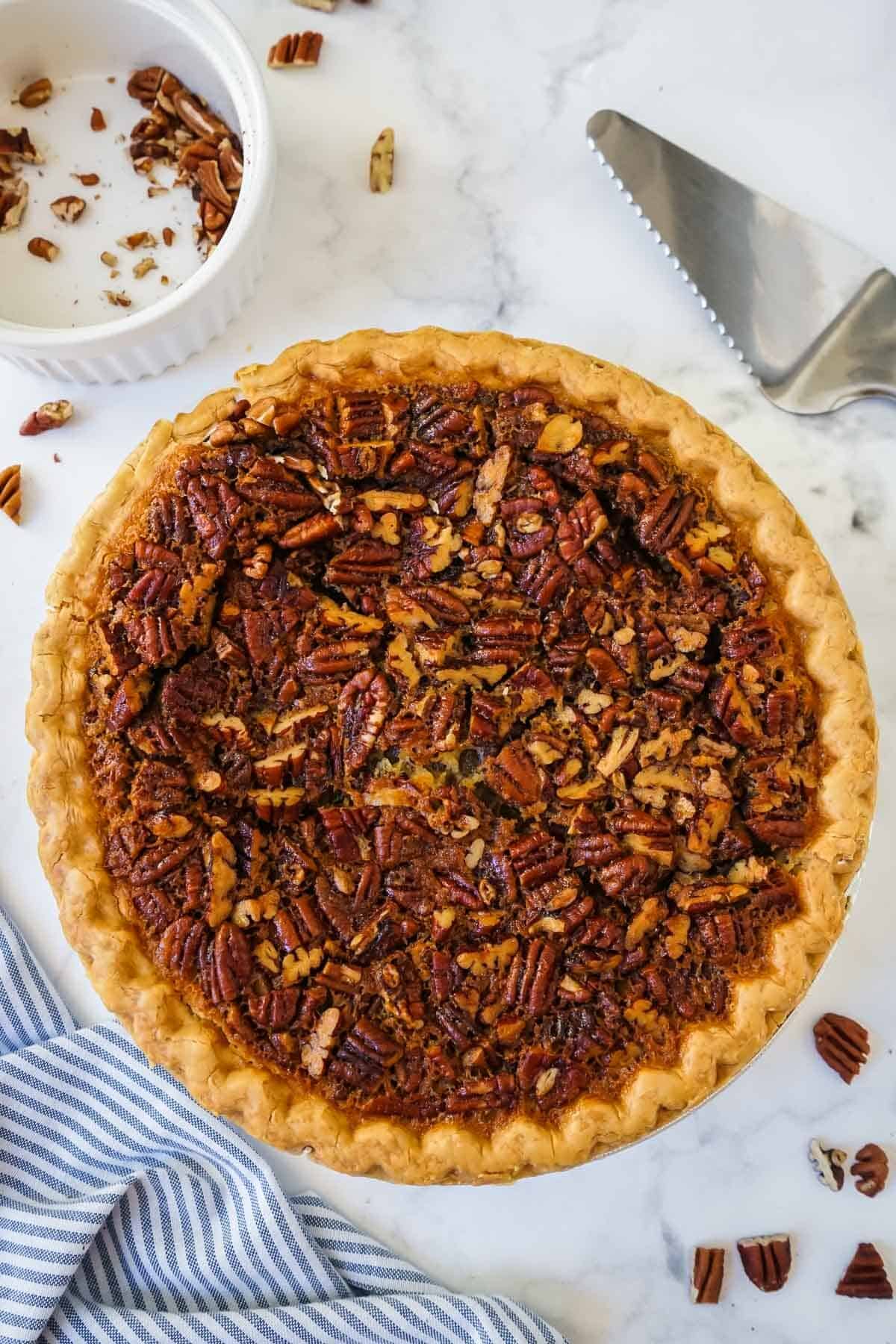 Fully cooked pecan pie without corn syrup with pecans all around it.