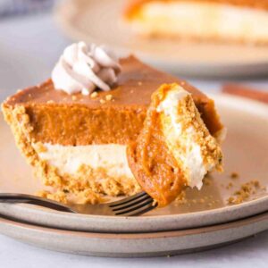 Double layer pumpkin pie on a plate with a fork.