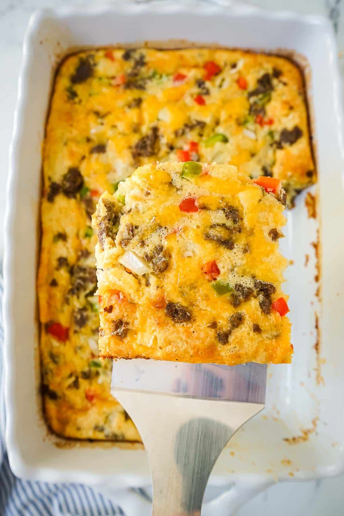A close up of a piece of Bisquick Breakfast Casserole on a spatula.