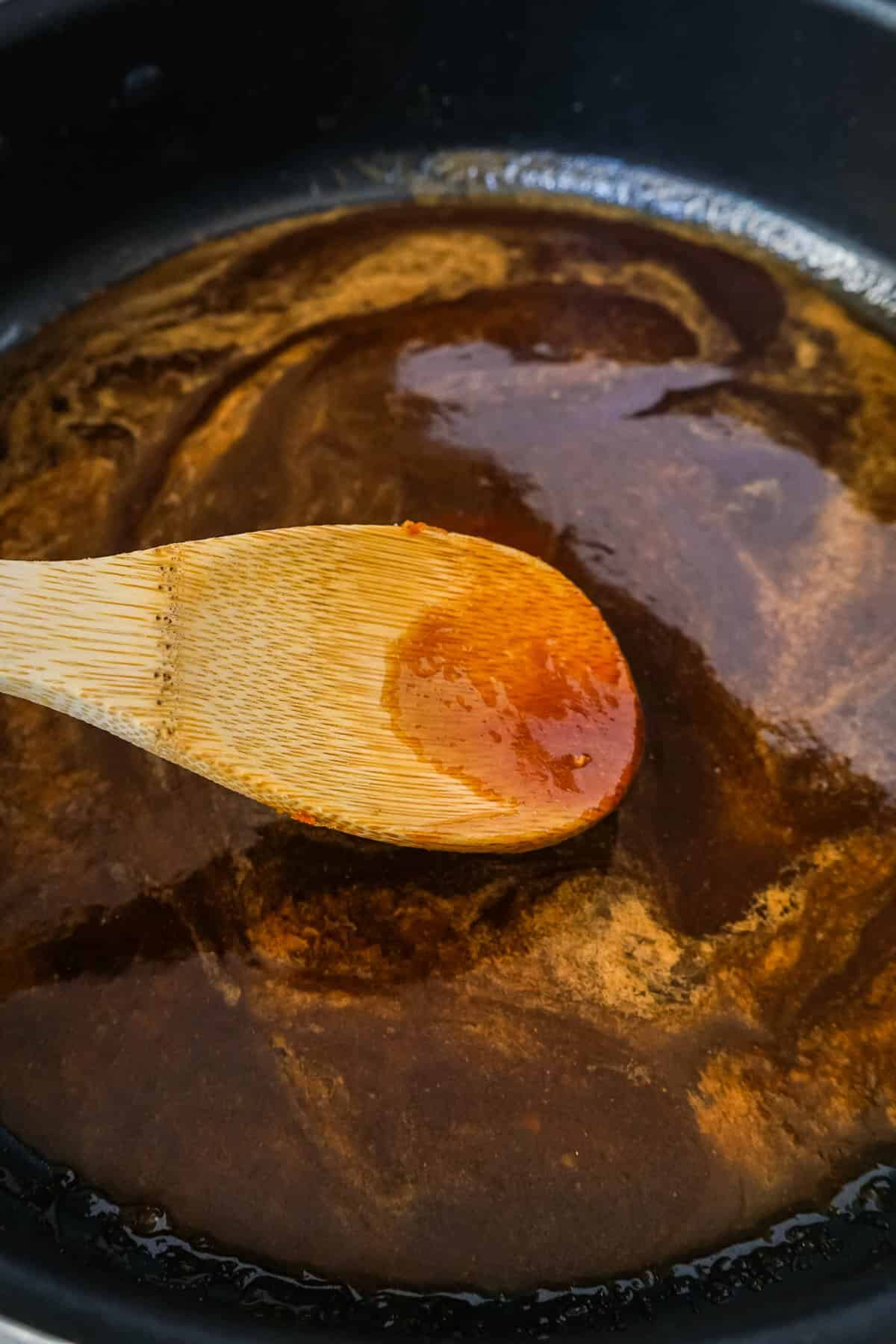 Close up of the glaze cooking in the skillet.