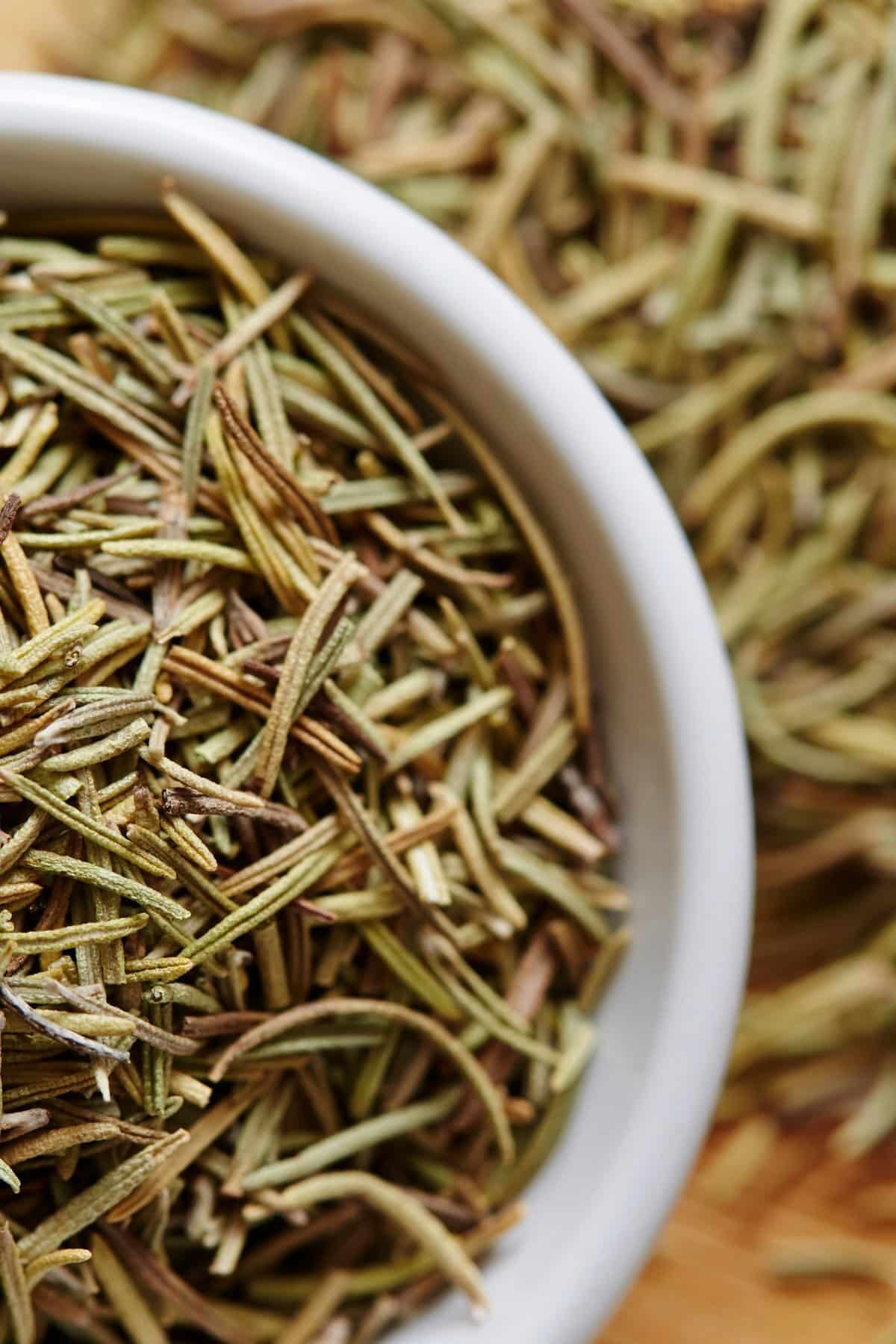 Photo of a bowl of dried rosemary.