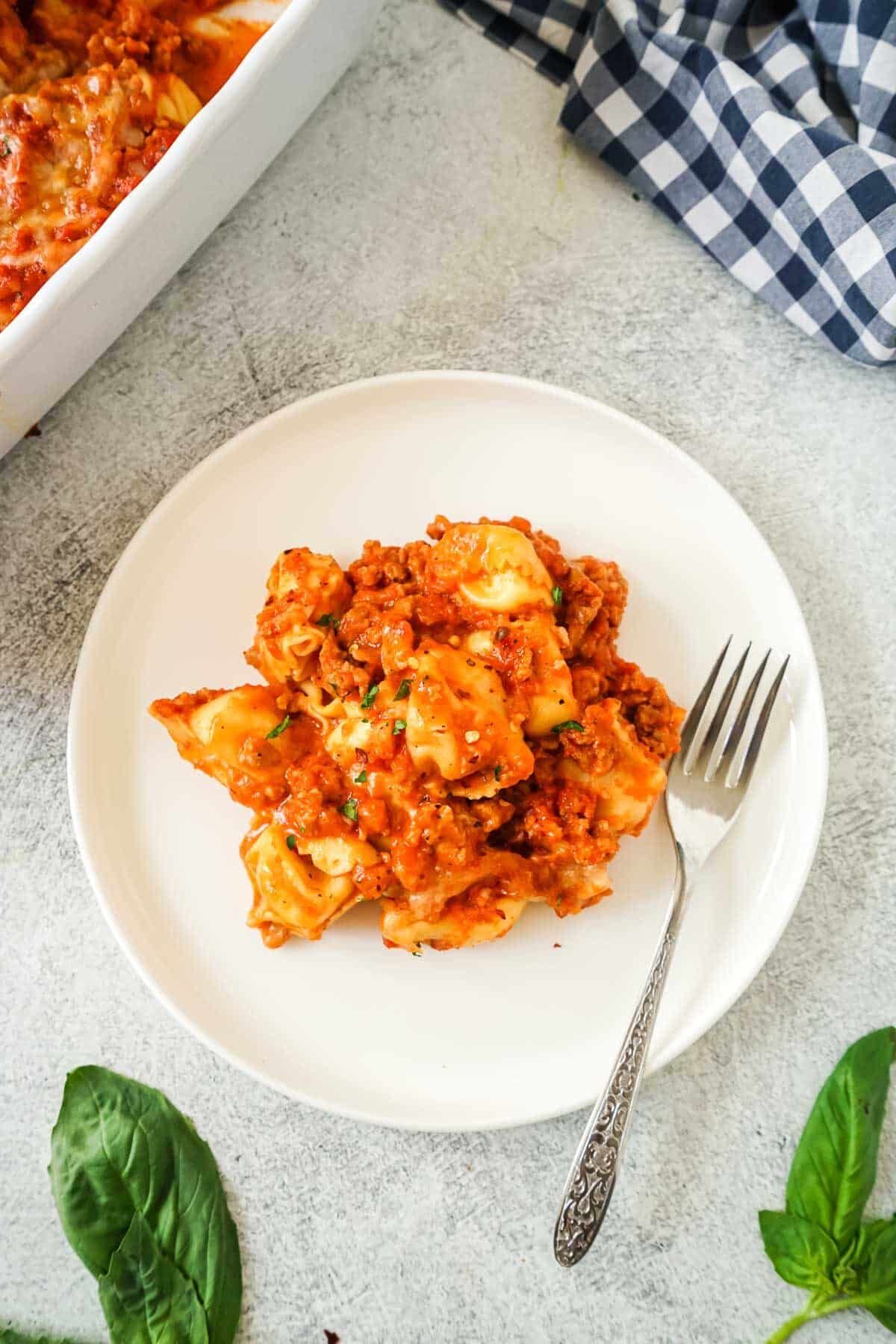 Easy Tortellini  Casserole on a white plate with a fork.