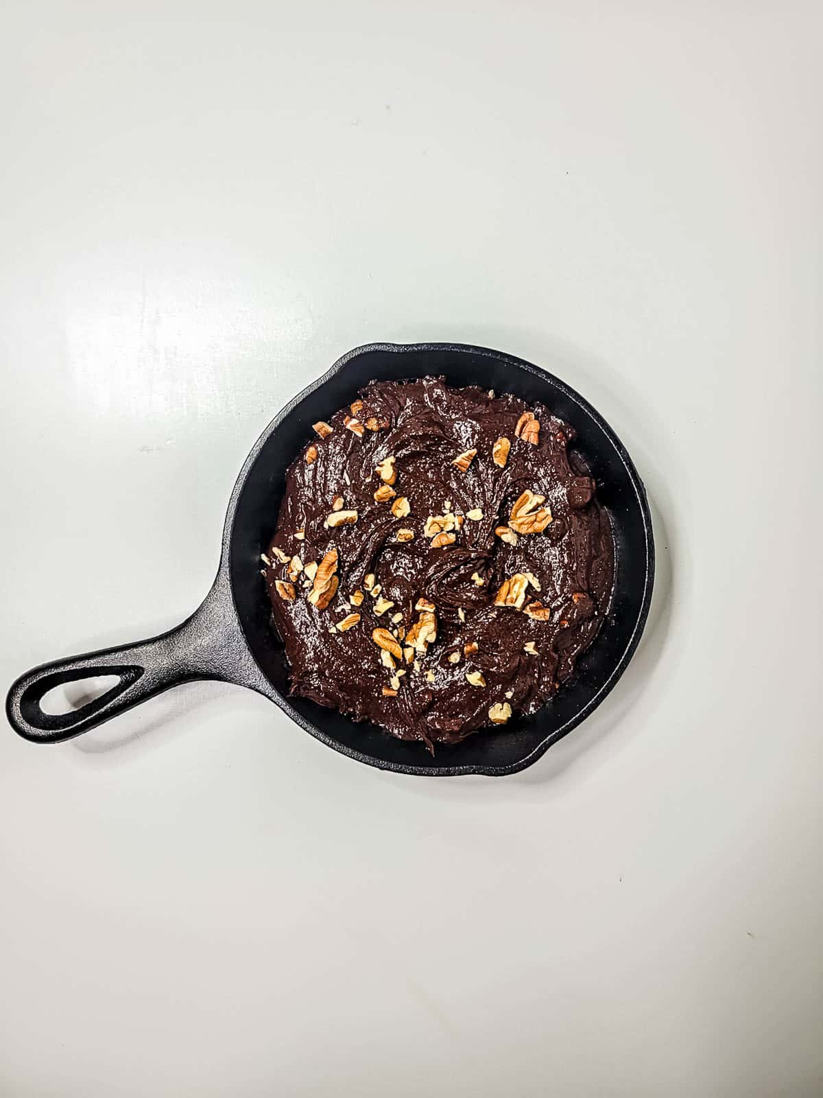 Cast iron skillet brownie before being baked.