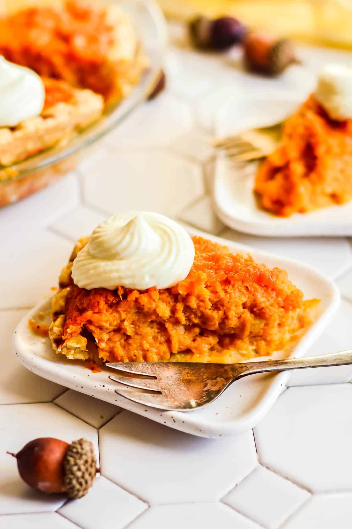 Grandma's Old Fashioned Sweet Potato Pie on a white plate with a fork.