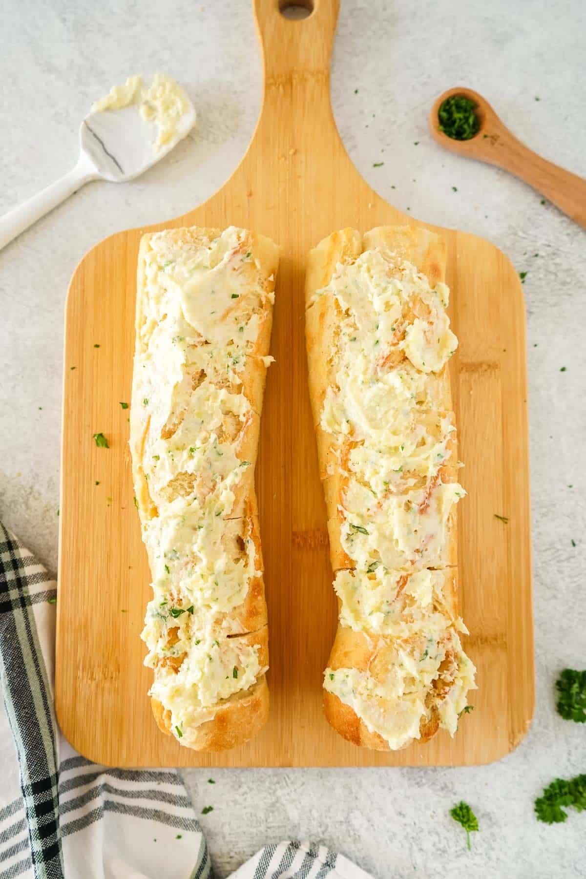 Baguette slathered with the garlic butter mixture.