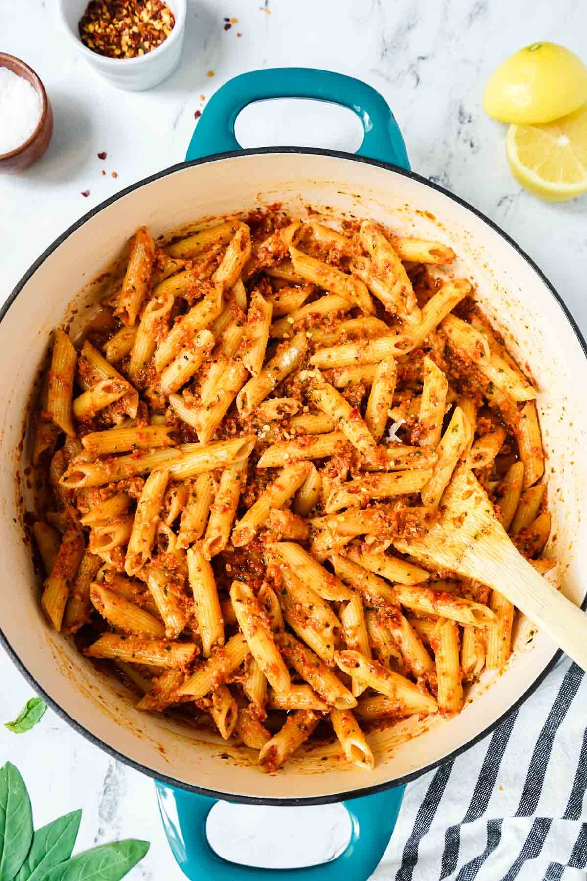 Easy Sun-Dried Tomato Pesto Pasta in a large skillet with a wooden spoon.