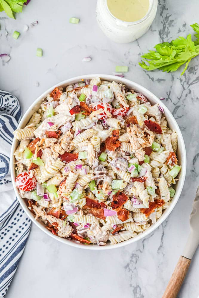 Chicken bacon ranch pasta salad in a white serving bowl.