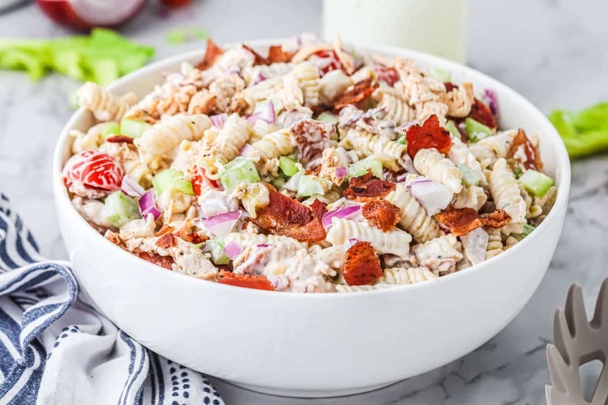 Chicken Ranch pasta salad with Wingstop Ranch in a large serving bowl.