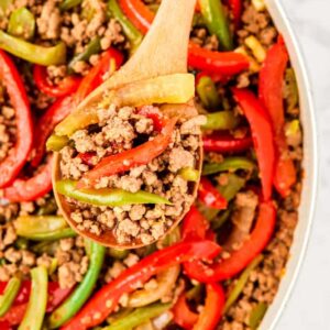 ground beef and peppers in a white skillet