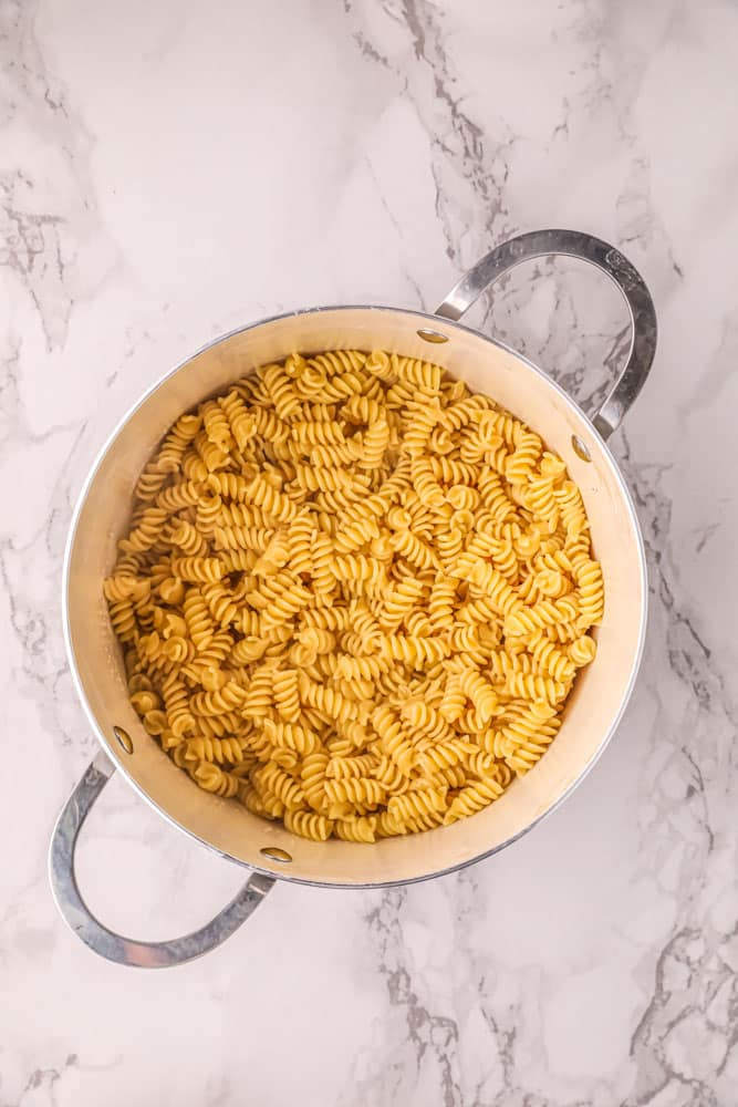 Rotini pasta cooking in a large stockpot.