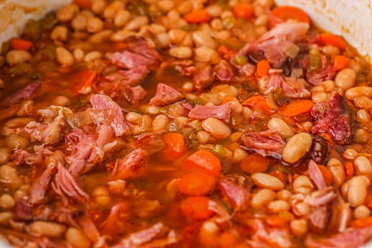 A close up photo of the ham and bean soup in the crockpot. 