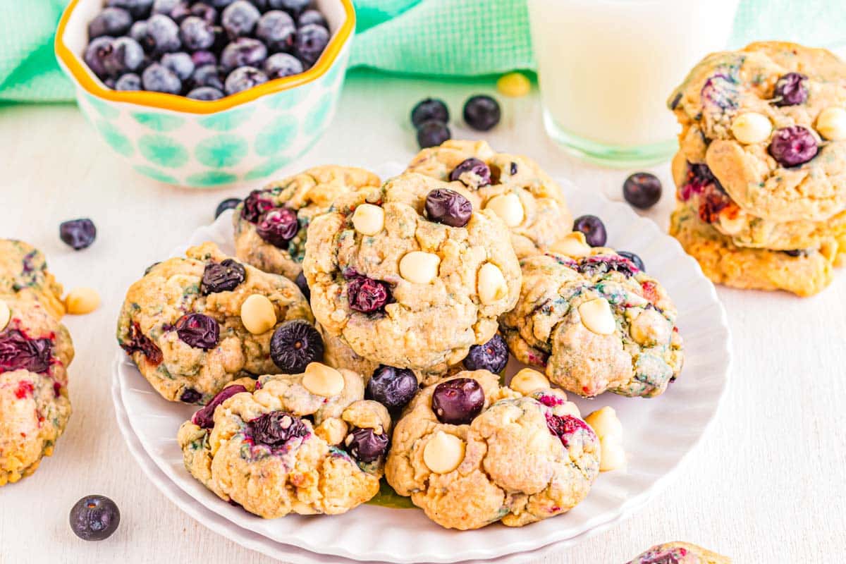 Blueberry white chocolate chip cookies on a large white serving plate.