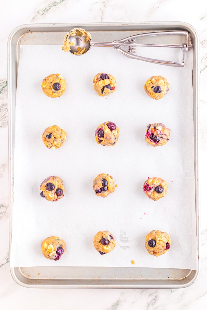Blueberry white chocolate chip cookies rolled into balls before being baked.