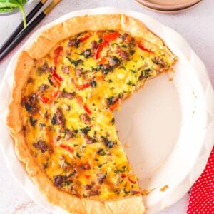 Spinach and sausage quiche with 2 slices removed