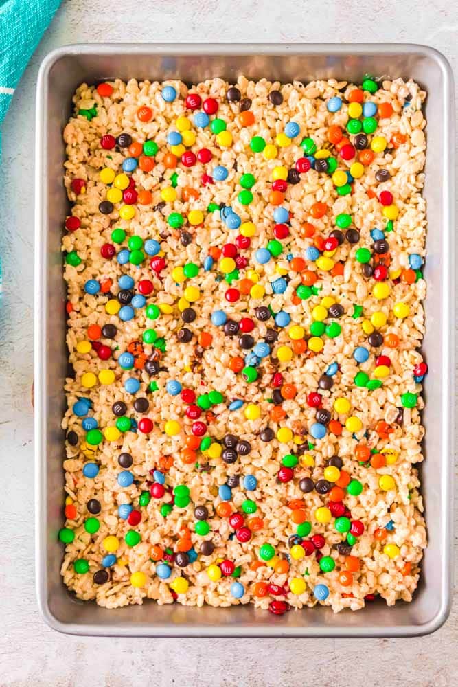 A baking dish with M&M Rice Krispie Treats before being cut.