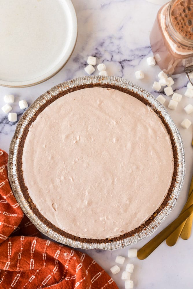 hot chocolate pie in a tin baking dish before being topped with chocolate and marshmallows