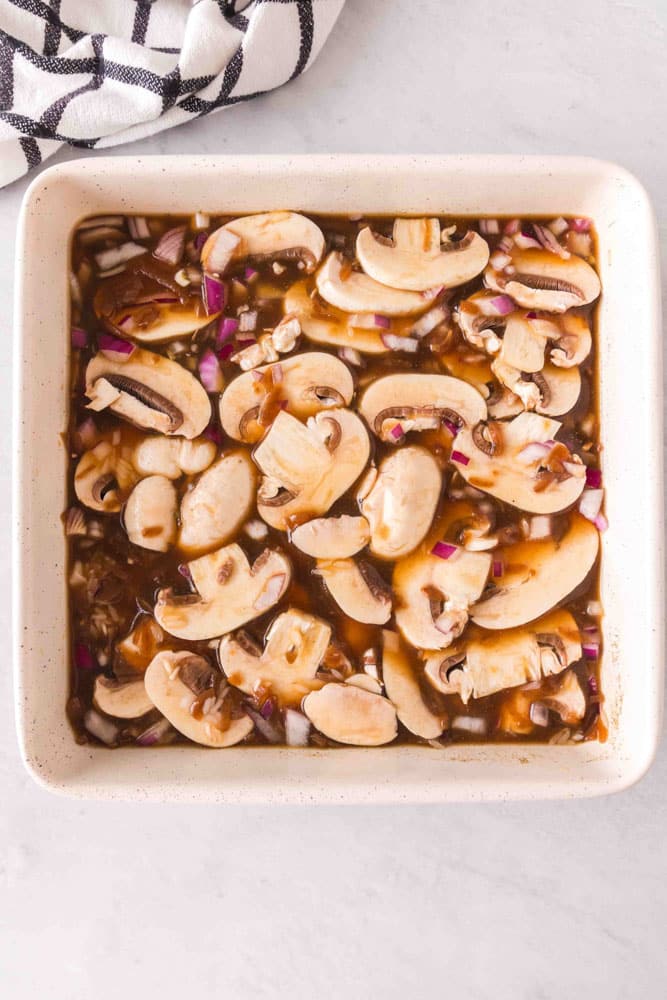 Campbell's Beef Consomme Rice and mushrooms in a baking dish.