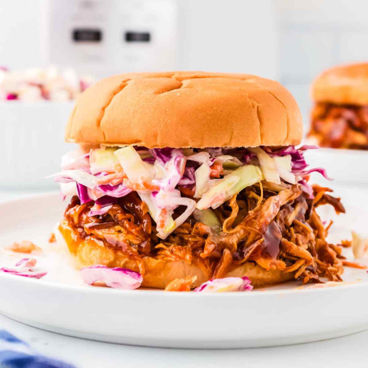 Crockpot bbq pulled chicken on a burger bun with cole slaw.