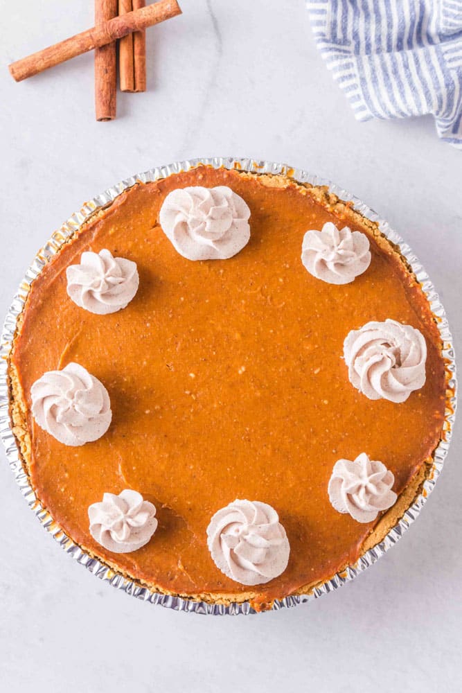 Pumpkin pie with dollops of cinnamon whipped cream.