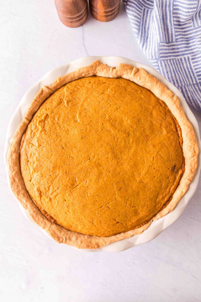 Sweet potato pie fresh out of the oven in a white ceramic pie dish