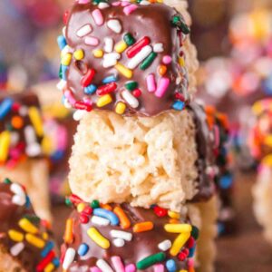 Chocolate covered rice krispie treats with sprinkles.
