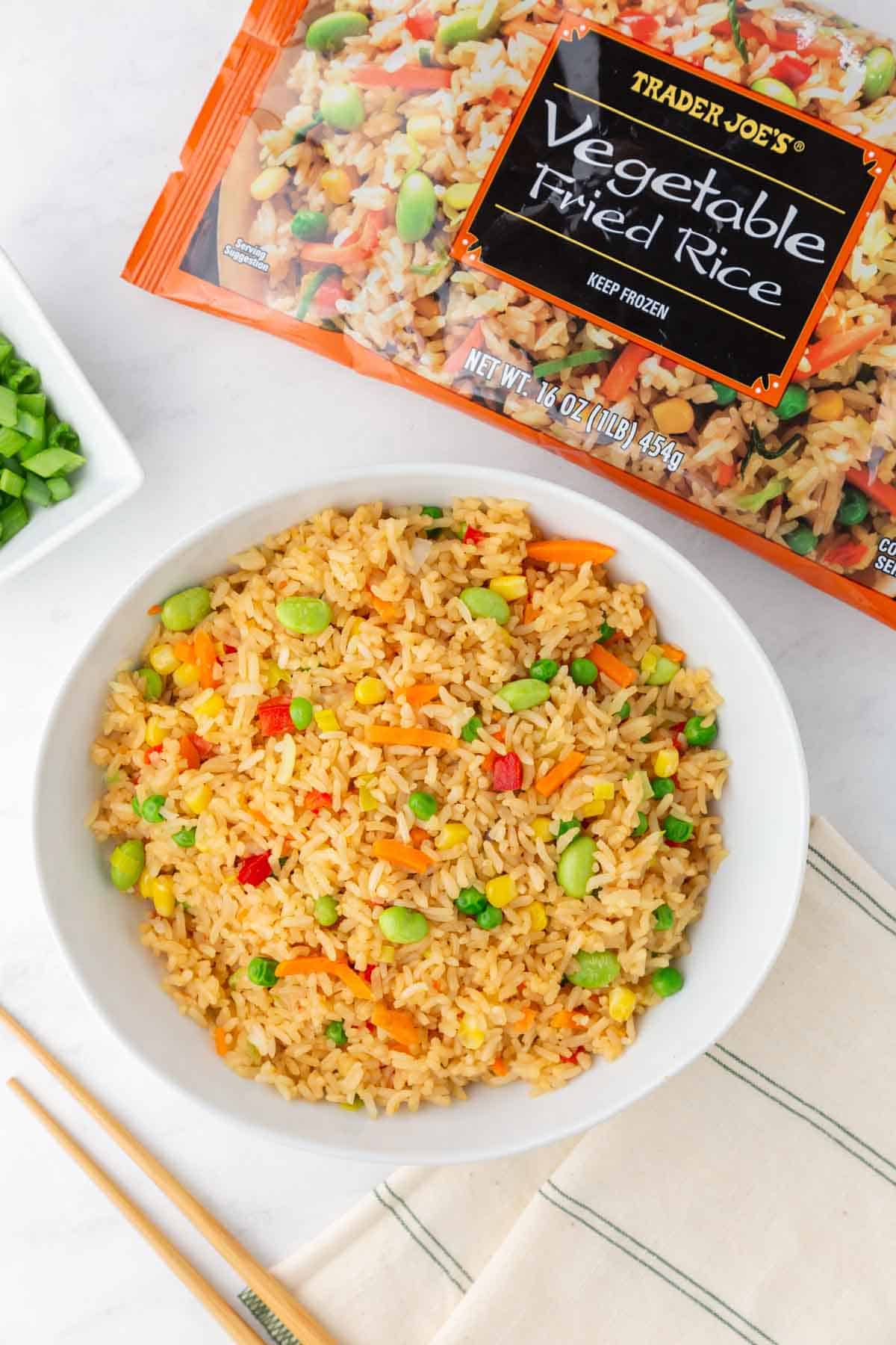 A bowl of Trader Joe's Vegetable fried rice in a bowl with the package.