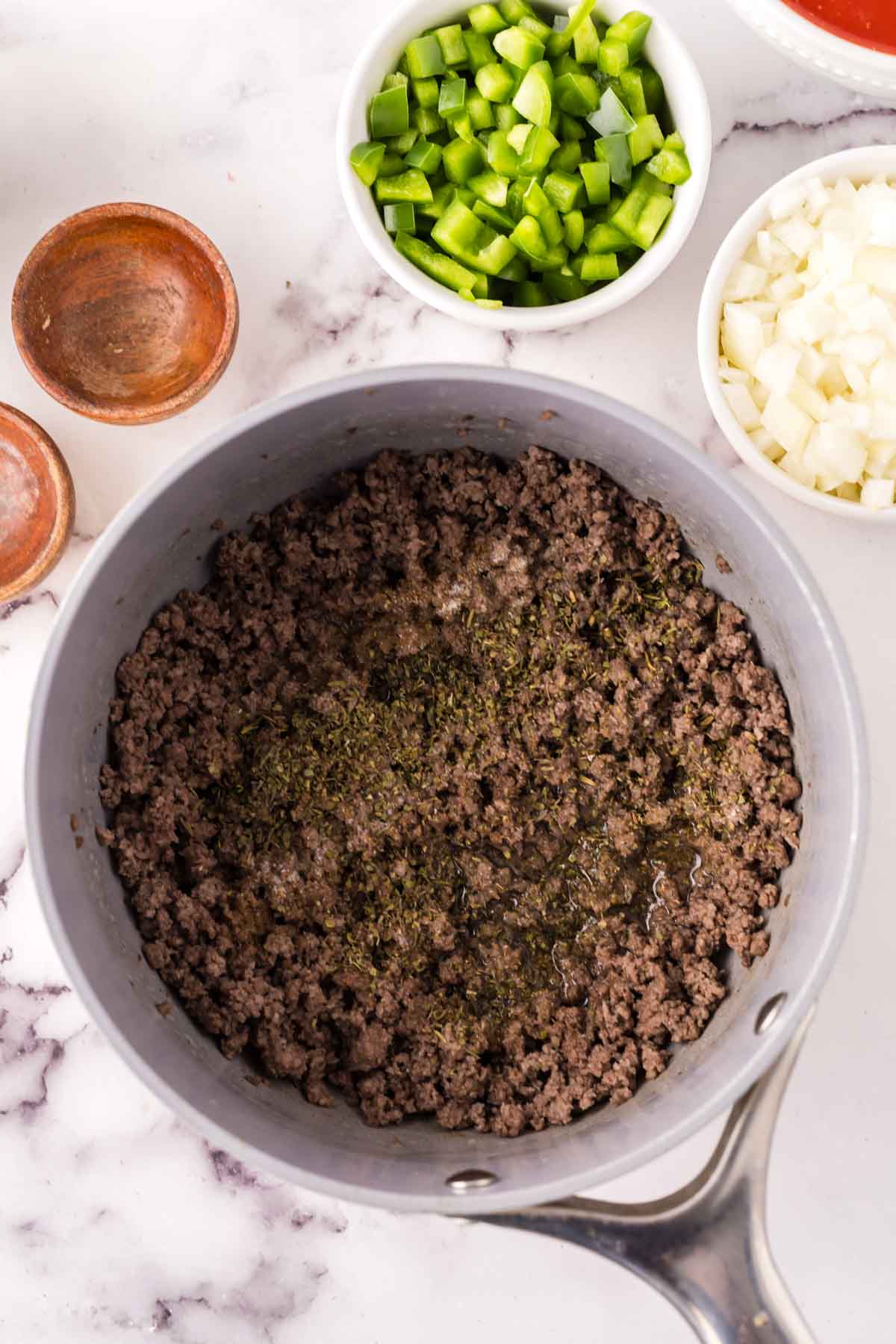 Ground beef cooking in a pan with spices.