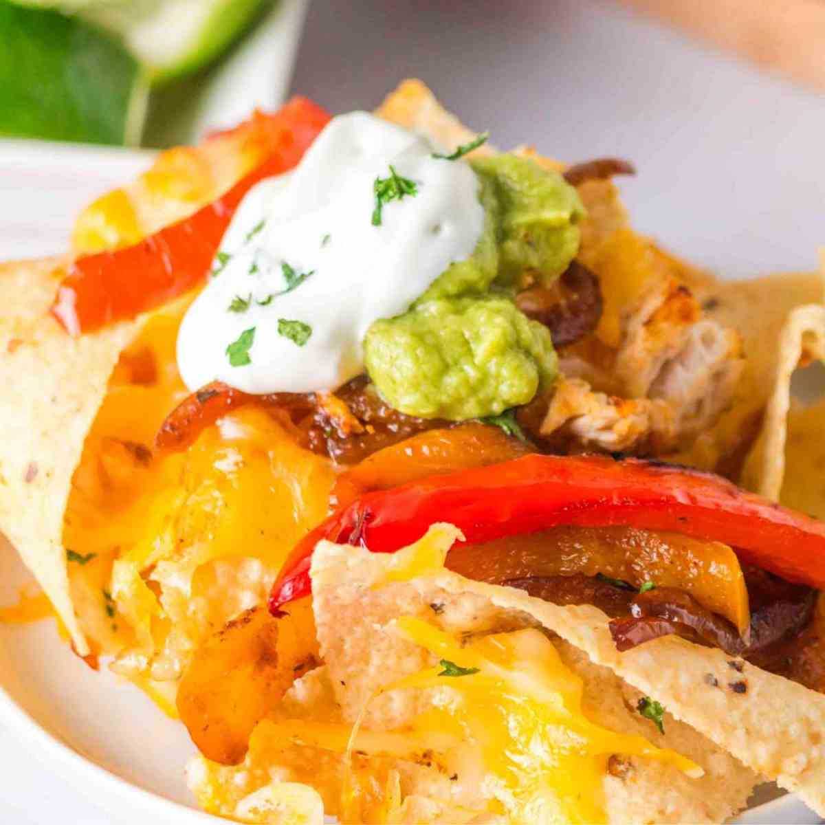 Featured image of fajita chicken nachos on a plate.