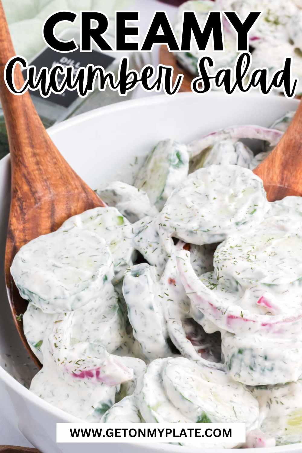 Pinterest Pin of creamy cucumber salad with mayo and sour cream on a wooden spoon.