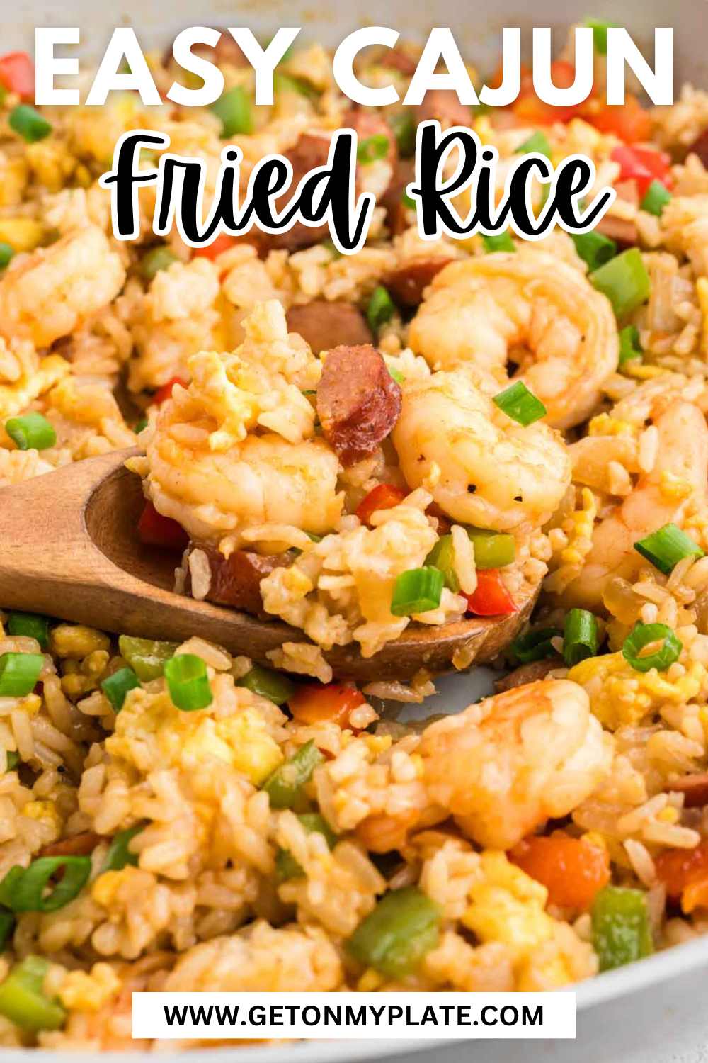 Pinterest pin wit Cajun Fried rice on a wooden spoon.