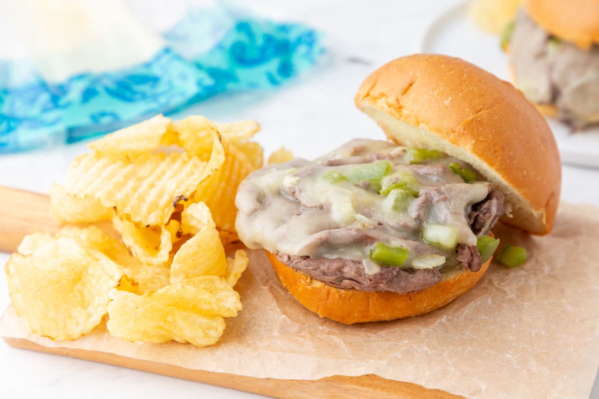 Trader Joe's shaved steak sandwich on a plate with chips.