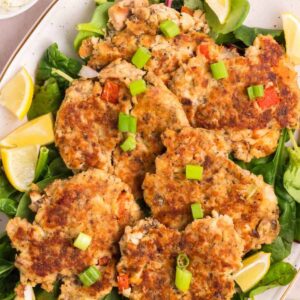 Featured image of salmon cakes made with canned salmon on a serving dish.