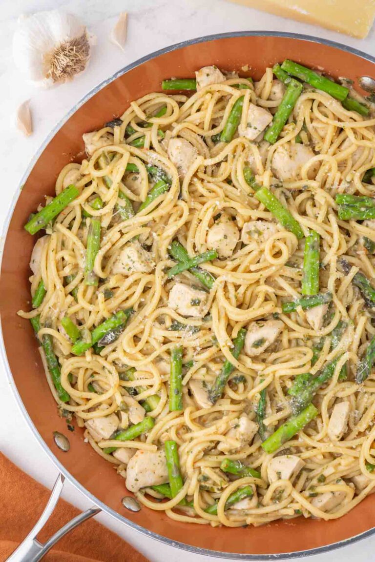 Trader Joe's Garlicky pasta with chicken and asparagus in a large skillet.
