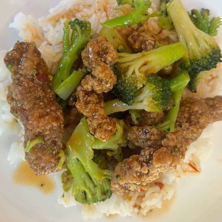 Trader Joe's Beef and Broccoli cooked in the air fryer on a white plate.