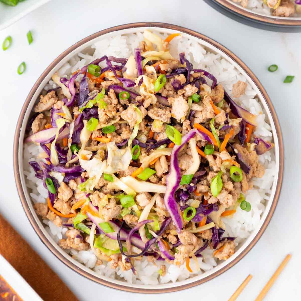 Trader Joe's Egg Roll bowl on a plate with chopsticks.