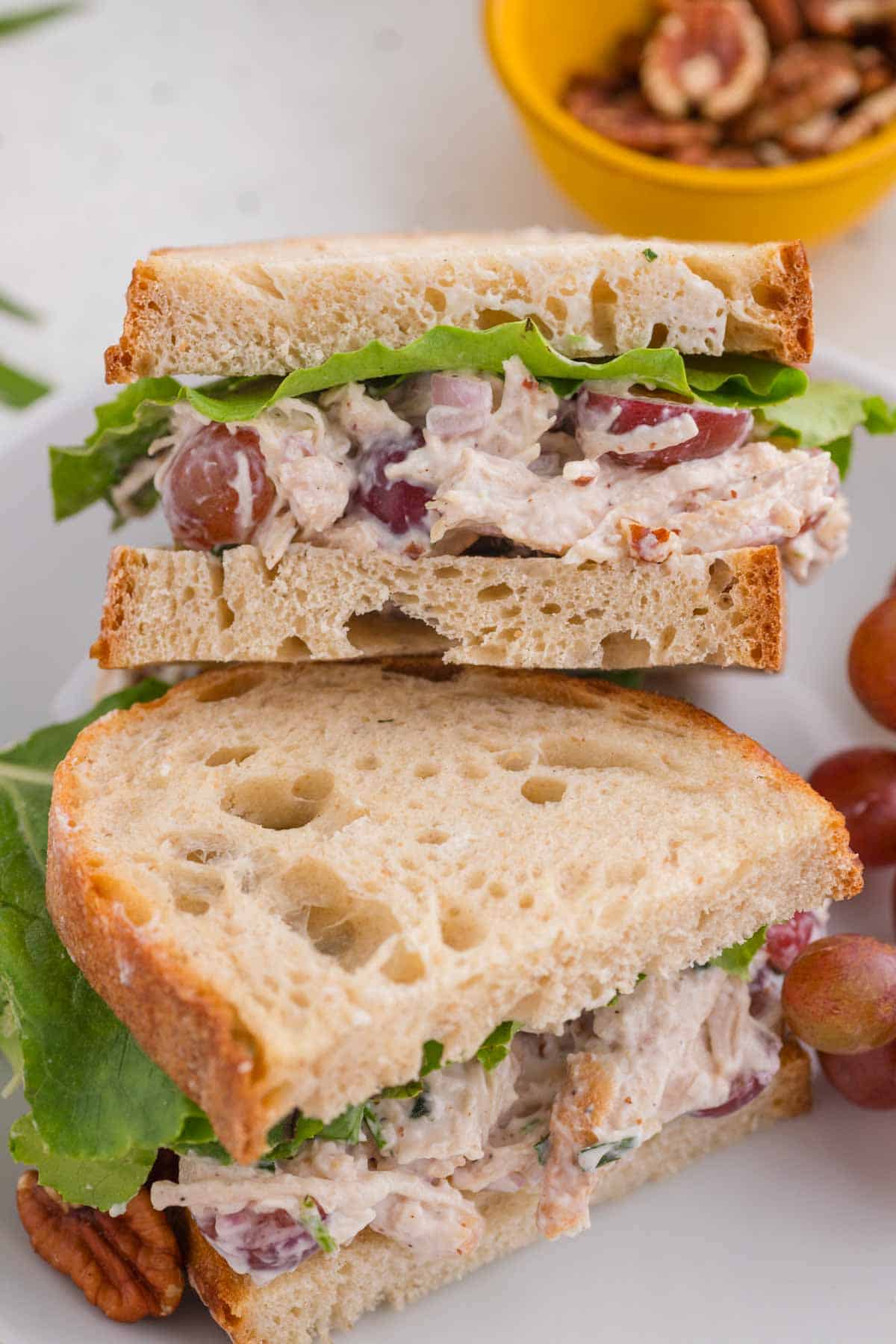 Tarragon chicken salad in sandwiches stacked on top of each other.