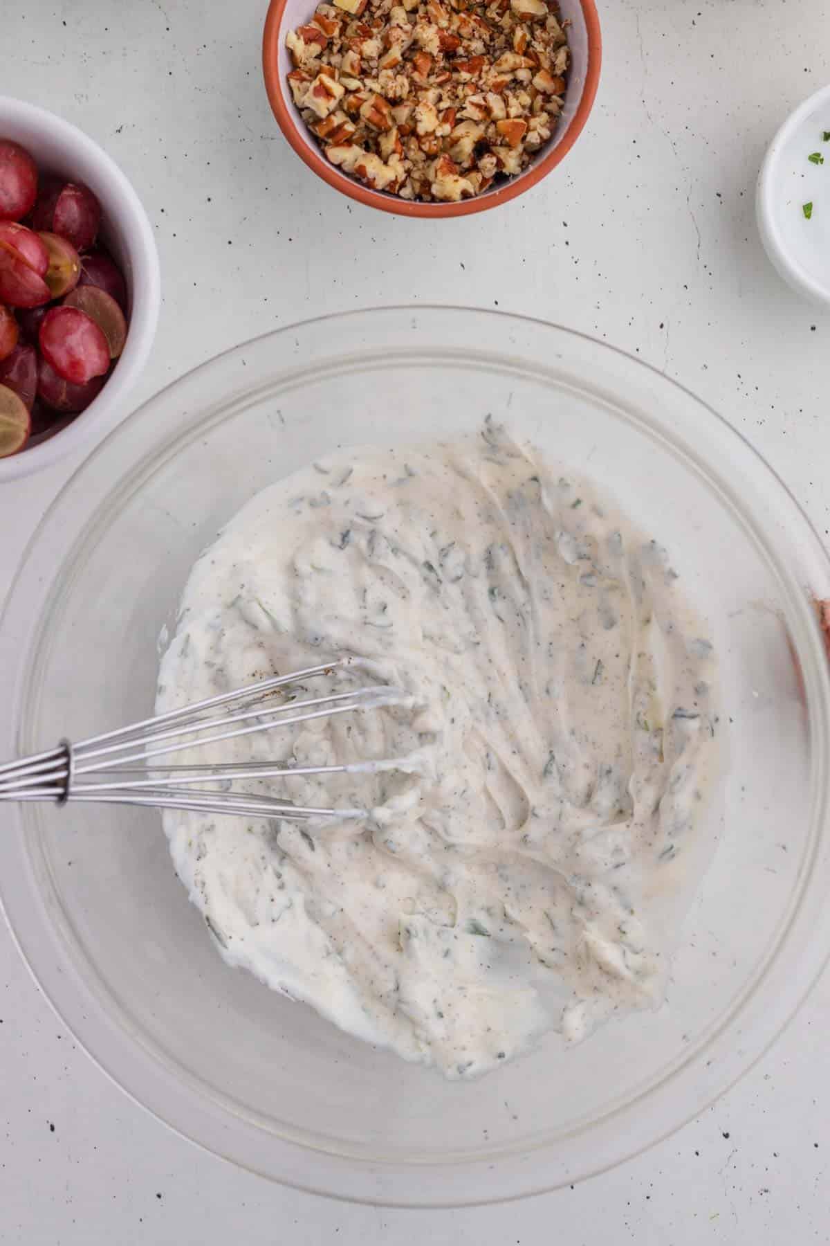 Dressing for the chicken salad being made in a bowl.