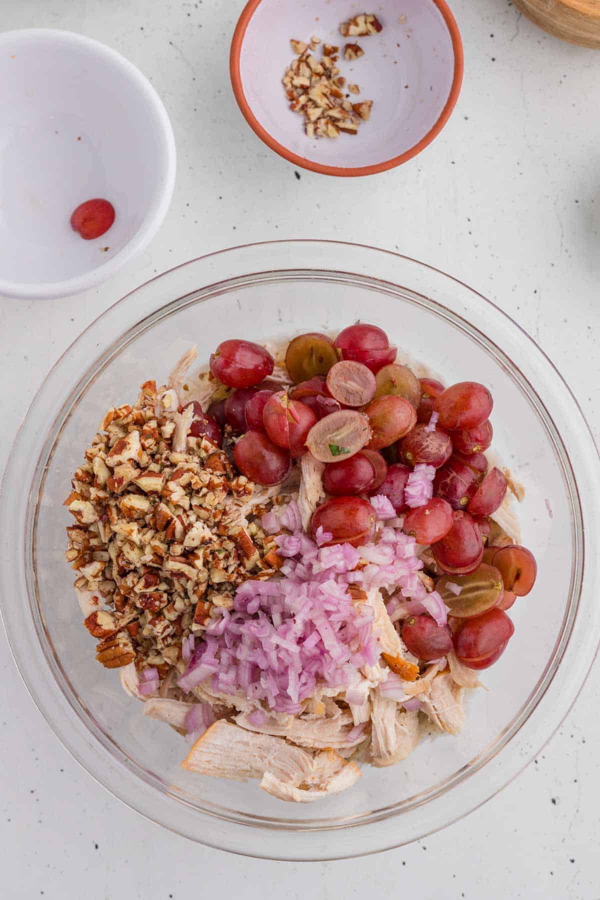 Other ingredients for the salad being mixed with the dressing.