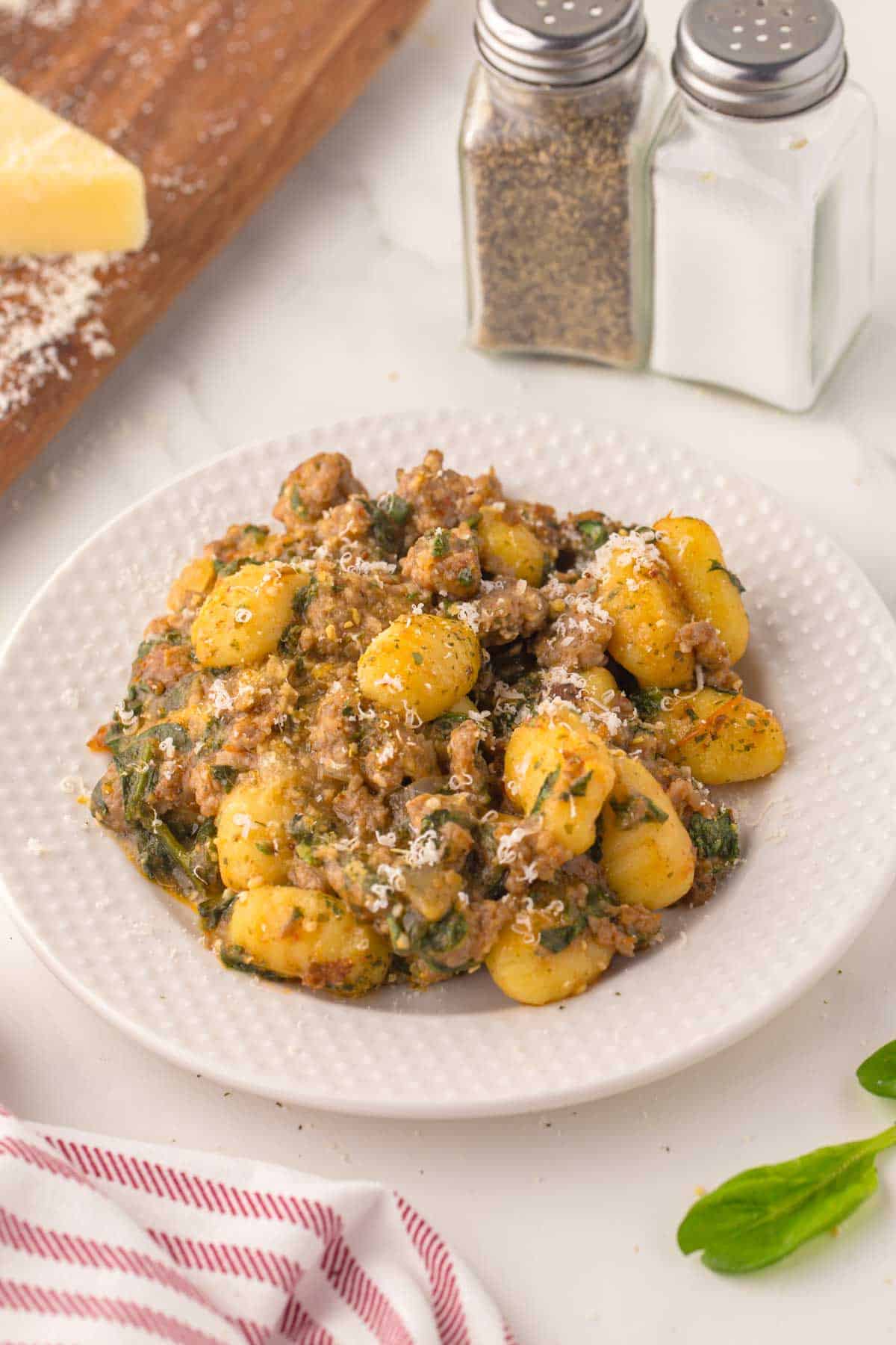 Trader Joe's sausage and spinach gnocchi on a white plate.