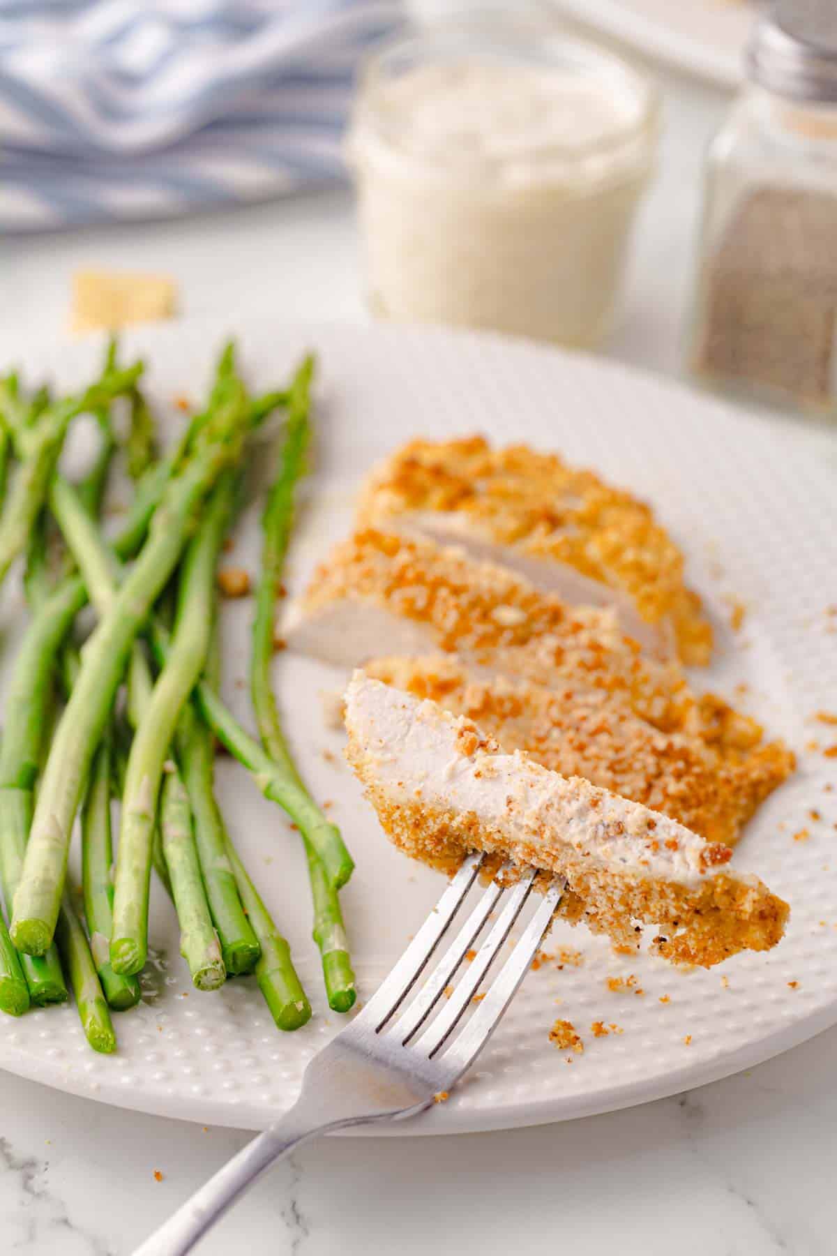 Piece of Caesar chicken bake on a fork.