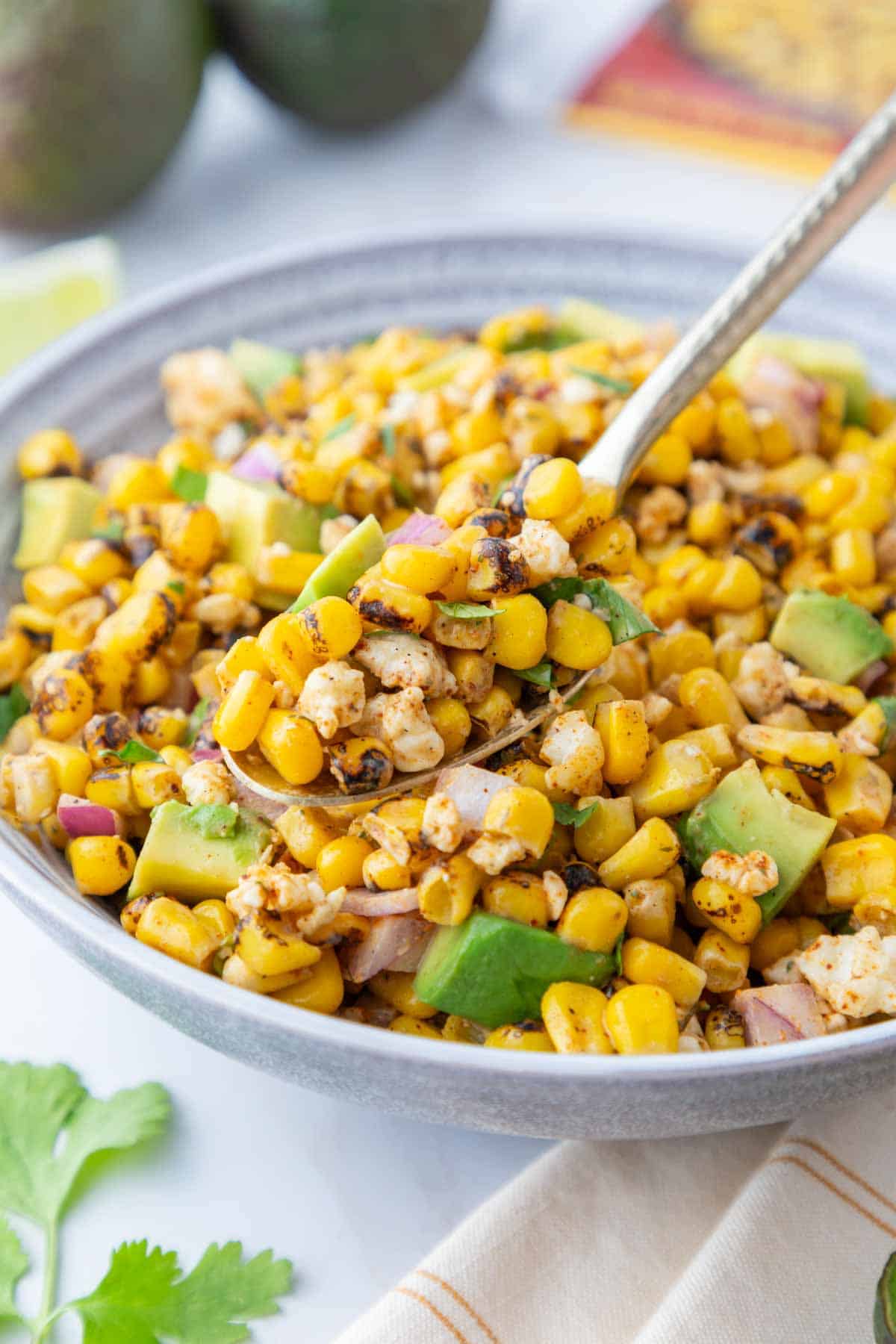 Elote corn salad on a spoon.