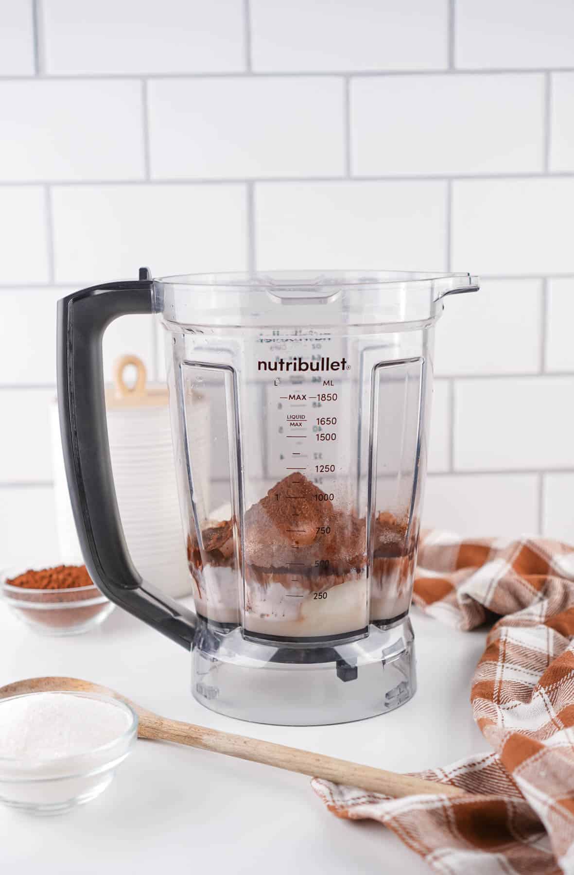 All ingredients to make hardboiled egg chocolate pudding in a blender.